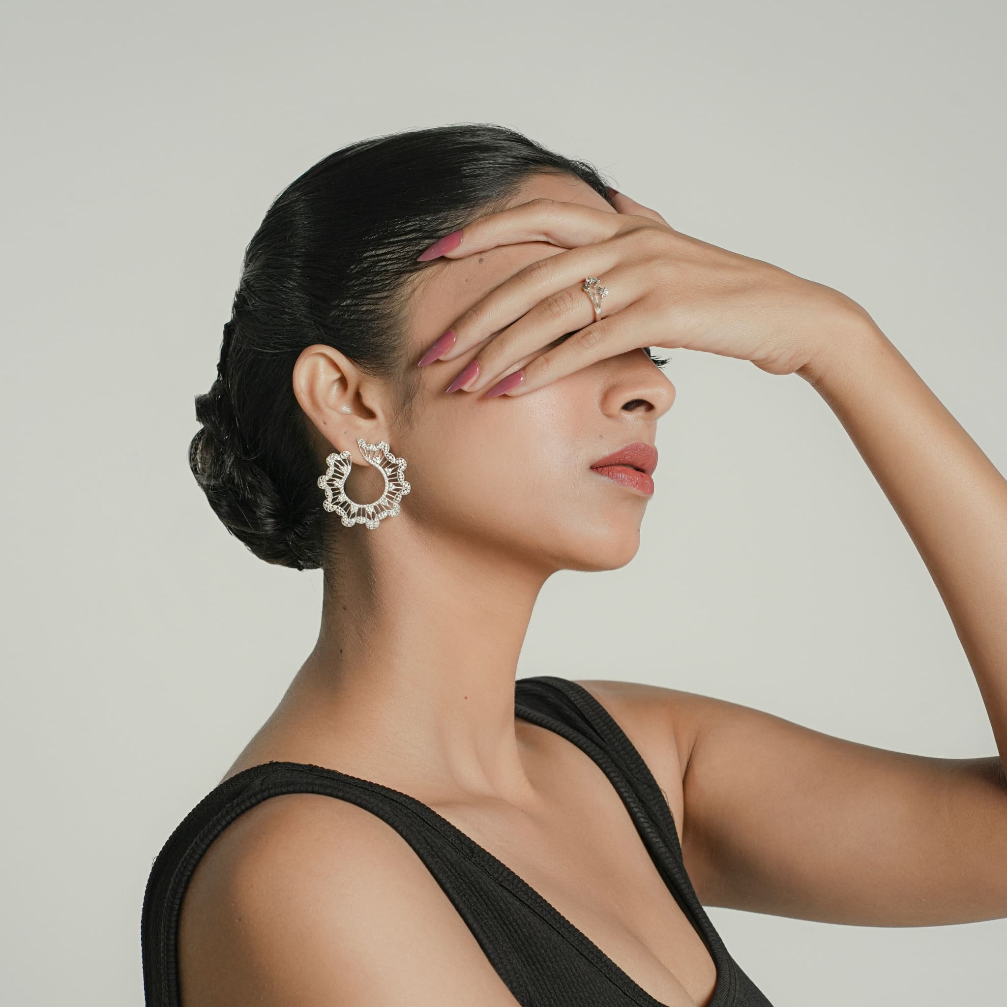 Model wearing silver CZ cluster hoop earrings