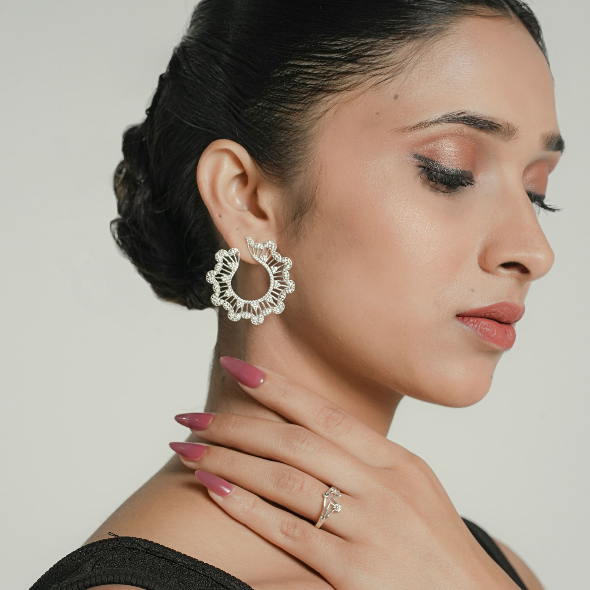 Model wearing silver CZ cluster hoop earrings