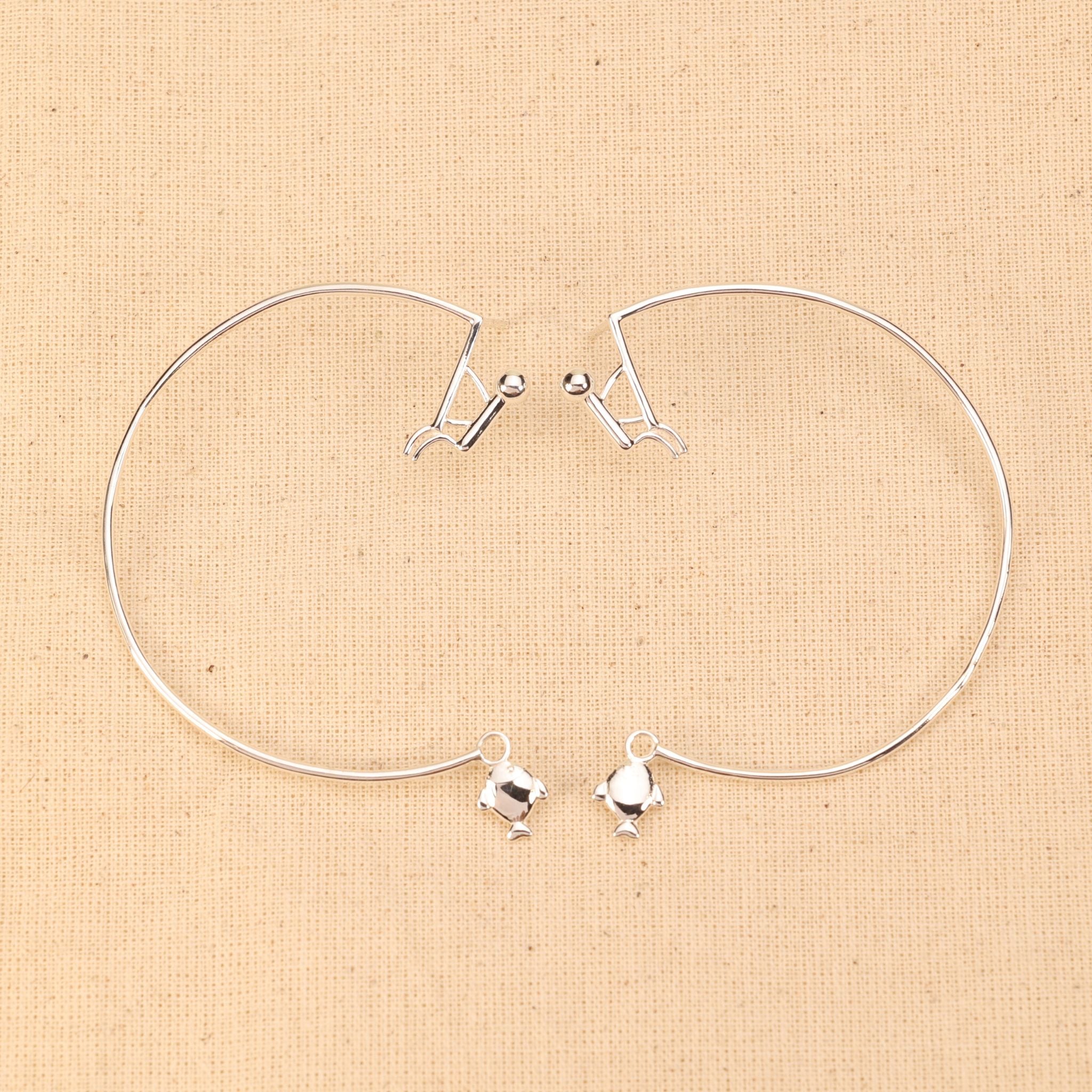 Fish Catching Hoop Earrings featuring a minimalist fisherman and fish charm design, 60mm large hoops in 92.5 sterling silver