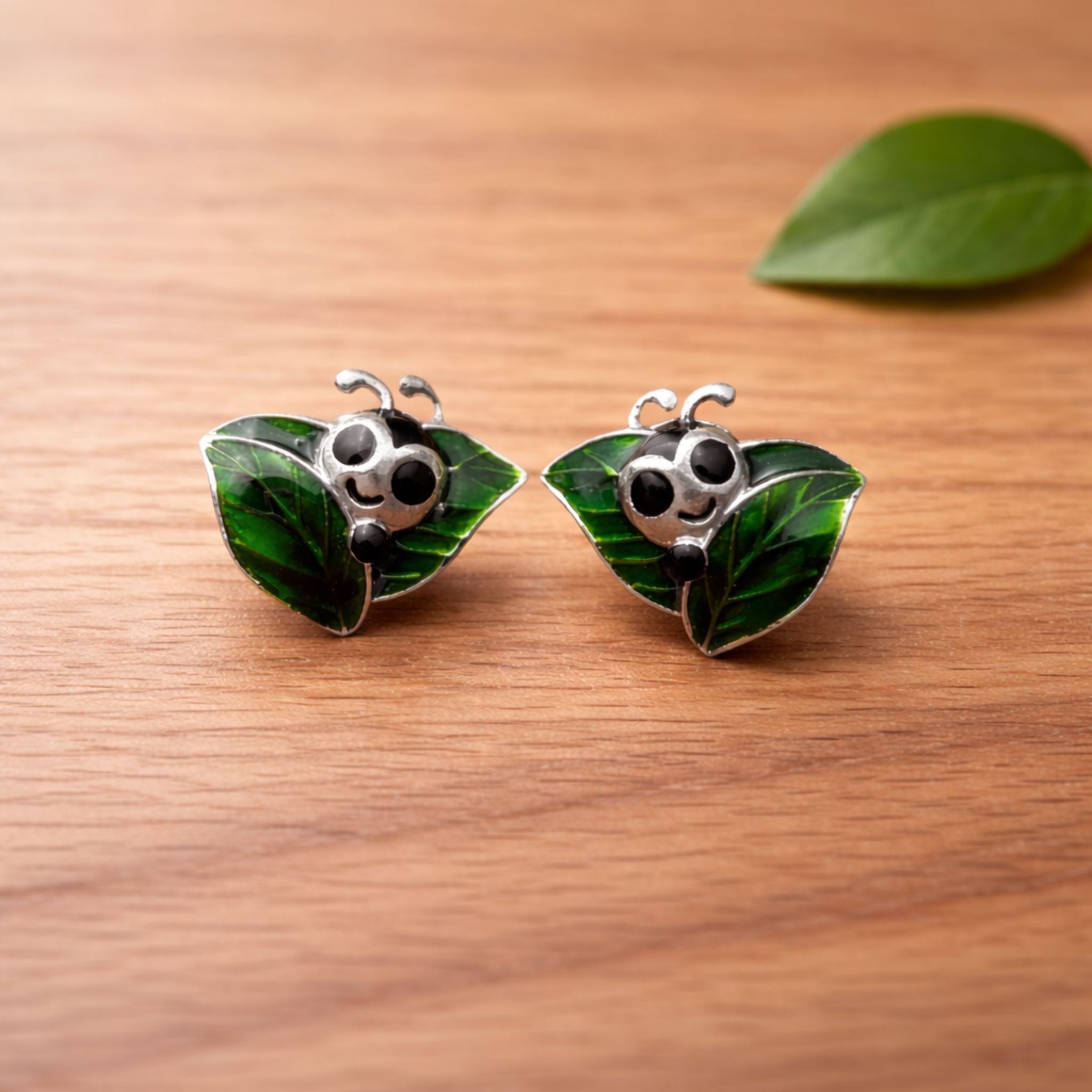 Caterpillar green enamel stud earrings crafted in 925 sterling silver