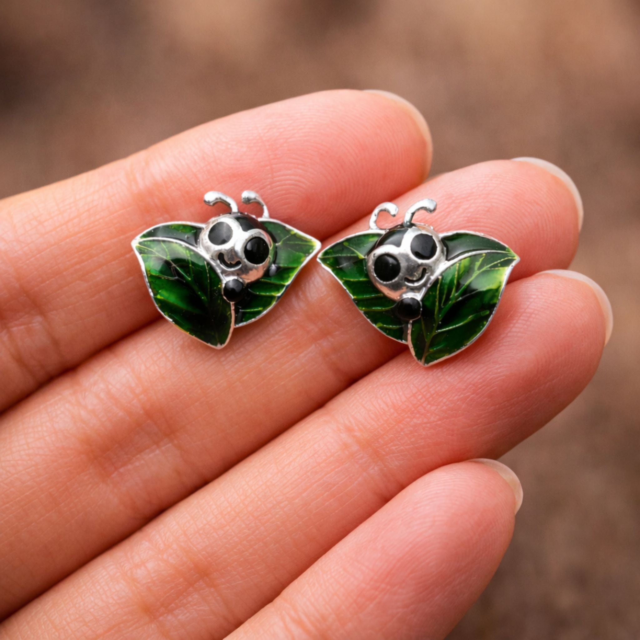 Caterpillar green enamel stud earrings crafted in 925 sterling silver