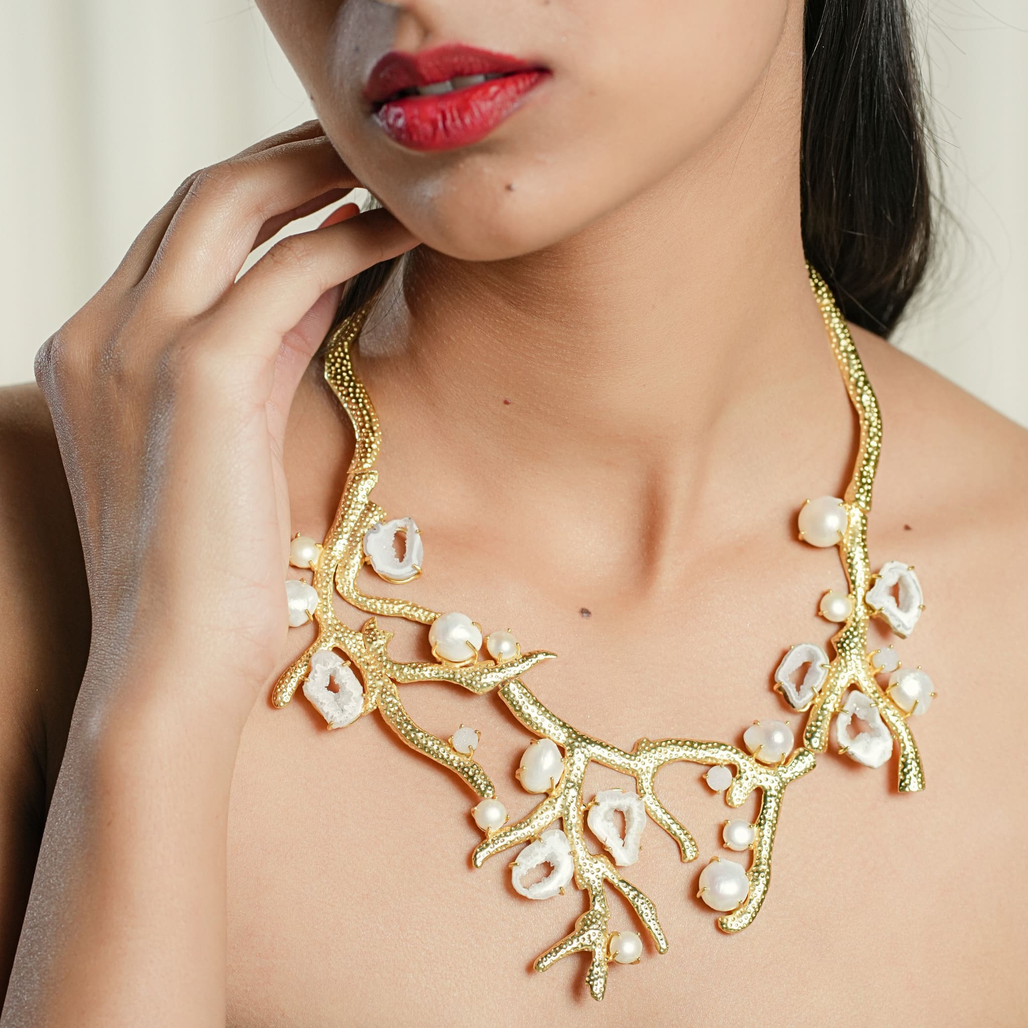 Model wearing branch-inspired silver necklace set