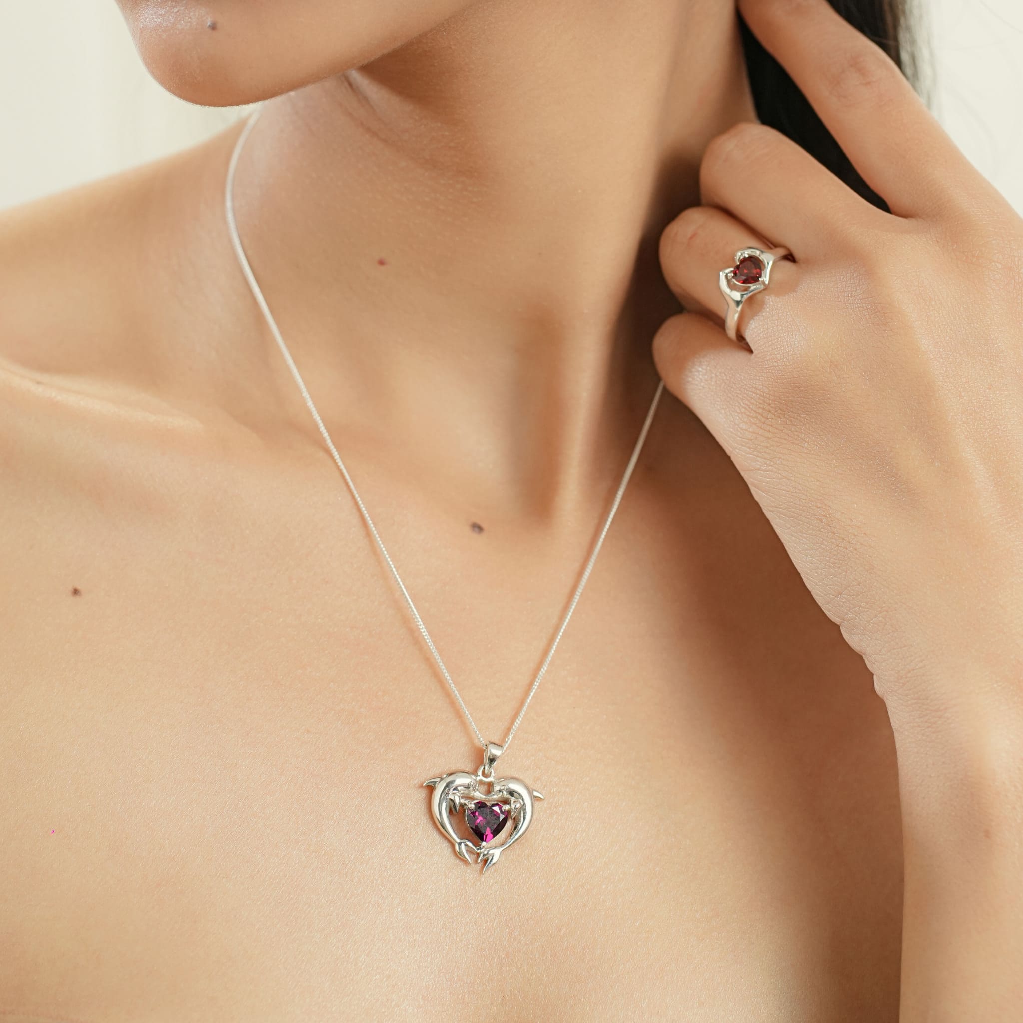 Model wearing silver heart garnet ring