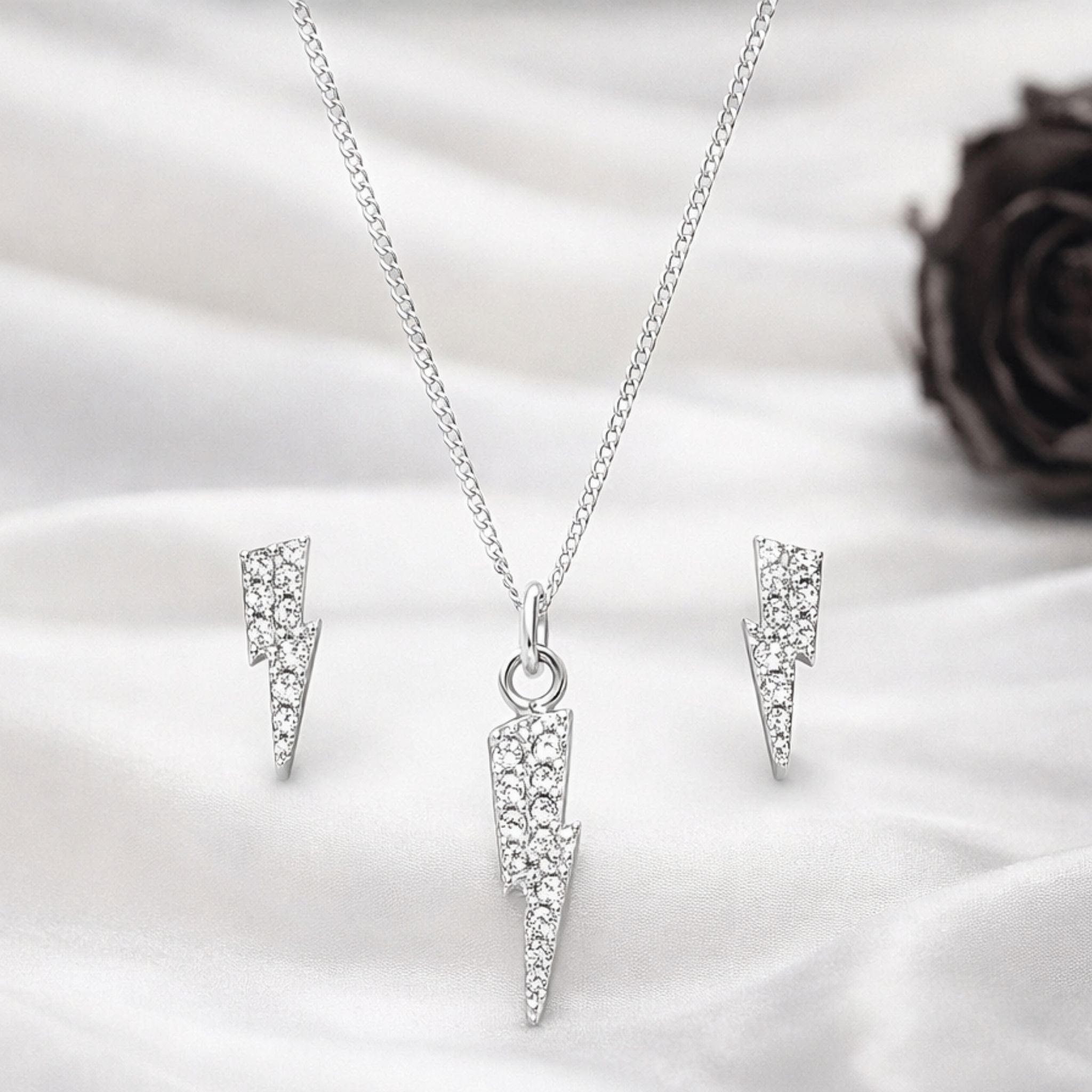 Model wearing silver thunder pendant with CZ stones