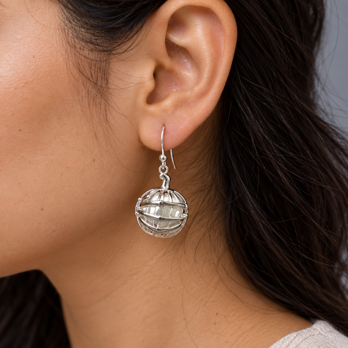 925 sterling silver pumpkin earrings with skeleton hand in black enamel detail. Unique gothic dangle earrings for Halloween, spooky styling and statement looks.